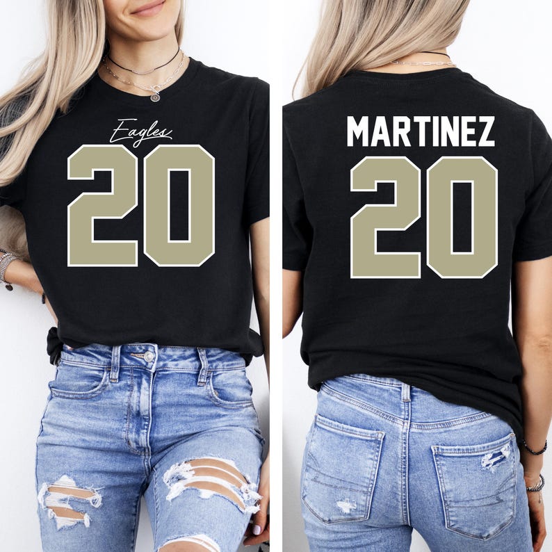 May include: Black t-shirt with the word "Eagles" and the number "20" in a tan, block-style font on the front. The back of the shirt displays the name "MARTINEZ" above the number "20".