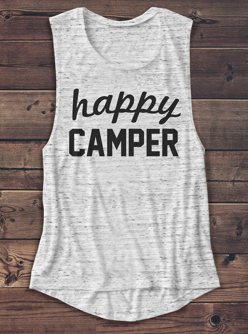 May include: A sleeveless white and gray marbled tank top with the words "happy CAMPER" printed in black. The top has a scoop neck and a curved hemline. The shirt is made of a soft, lightweight material.