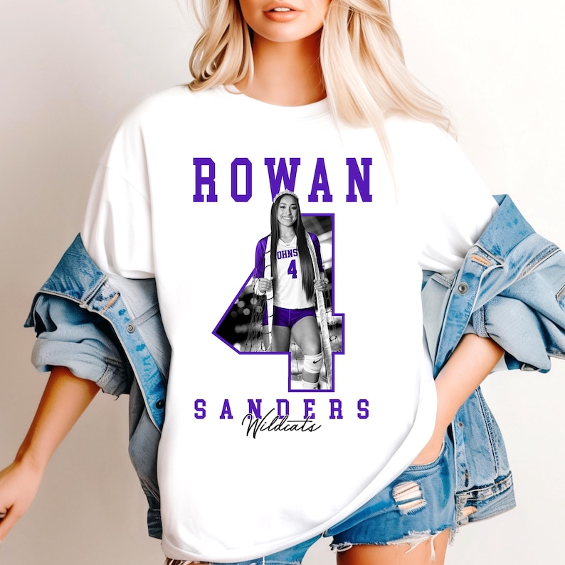May include: White t-shirt with the name "ROWAN" in purple block letters. A photo of a volleyball player in a purple and white uniform is integrated into a large purple number "4". The name "SANDERS Wildcats" is printed below the number.