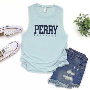 May include: Light blue sleeveless tank top with the text "PERRY BASEBALL" in navy blue lettering.