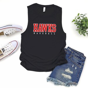 May include: Black sleeveless tank top with the words "HAWKS BASEBALL" in red letters.