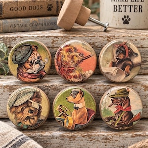 May include: Six round wooden cabinet knobs featuring colorful illustrations of dogs in various outfits and activities, including a bulldog with a pipe, a dog in a car, and a dachshund with a hat. Each knob has a smooth finish and a metal screw.