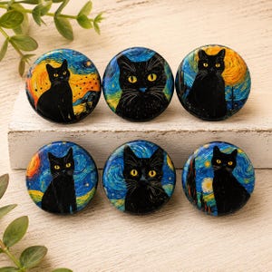 May include: Six circular buttons featuring black cats with yellow eyes set against a swirling blue and yellow background reminiscent of a starry night sky. Each button displays a unique cat pose or facial expression within the painted landscape.