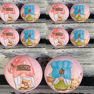 May include: A collection of pink, round decorative items featuring gnome illustrations. Some gnomes wear red hats and hold coffee cups, while others wear blue chef hats and hold coffee cups and cookies. The word "Coffee" is on a banner.