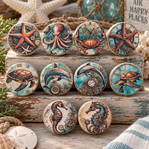 May include: A set of ten round cabinet knobs featuring nautical and steampunk designs. The illustrations include a starfish, octopus, crab, sea turtle, dolphin, and seahorse, all integrated with clock faces, gears, and cogs in shades of blue and brown.