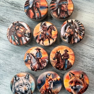 May include: Nine round wooden coasters with colorful images of Native American themes. The images include a Native American woman, a Native American man, a Native American riding a horse, a horse with a Native American headdress, a cowboy riding a horse, a woman riding a horse, a wolf, and two foxes.