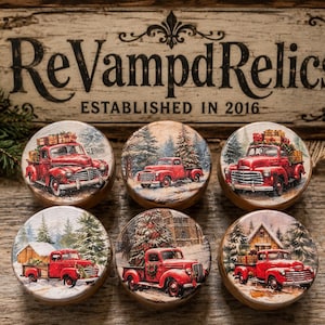 May include: Six round wooden ornaments featuring vintage red truck illustrations with Christmas trees and gifts in snowy winter landscapes. Each circular piece displays a different festive scene with pine trees, cabins, and holiday decorations.