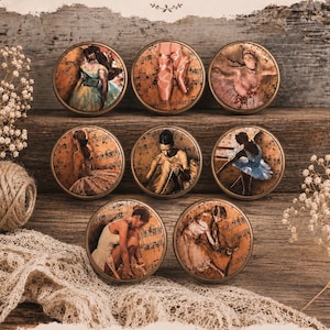 May include: Eight round cabinet knobs featuring circular inserts with sepia-toned ballet imagery, including dancers and pointe shoes overlaid on musical notation. The text "HANDMADE Ballet Knobs ART • MUSIC • DANCE" is printed at the top of the display.