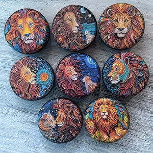 May include: Eight round, colorful, decorative, wooden boxes with lion images. Each box features a different lion design with intricate details and a variety of colors, including red, orange, yellow, blue, and green.