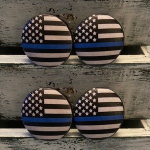 May include: Four round wooden drawer knobs with a thin blue line and an American flag design.