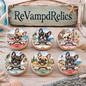 May include: Six round wooden drawer knobs featuring watercolor illustrations of French bulldogs driving cars. Each knob displays a different dog in a unique setting, including coastal, tropical, and lighthouse backgrounds, with colorful scarves.
