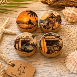 May include: Four wooden knobs with beach-themed designs. Each knob features a different image: a surfer at sunset, a surfer crossing sign, a vintage surf shop, and a surf shack. The knobs are 1.5 inches in diameter.