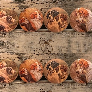 May include: Eight round wooden drawer knobs with a vintage look. Each knob features a different image of a brown and white hunting dog.