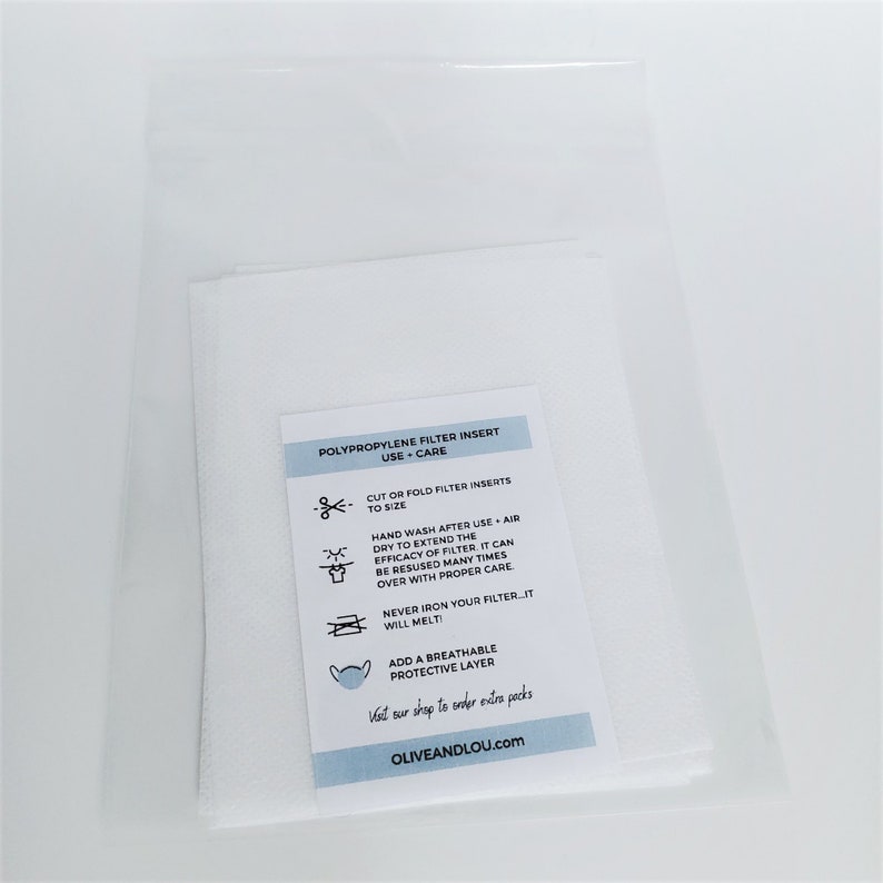 May include: A white package containing polypropylene filter inserts for face masks. The package includes instructions for use and care, including how to cut or fold the inserts to size, hand wash them after use, and never iron them. The package also mentions that the inserts can be reused many times with proper care.