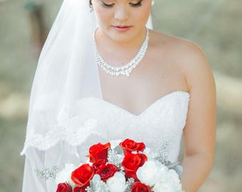 White 2 layer fingertip veil with beaded lace edge and blusher.