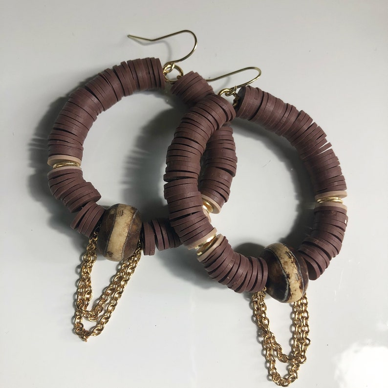 Brown beaded earrings with chain accents
