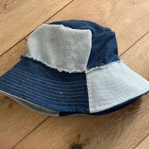 Peut inclure: Un chapeau bob en jean bleu et bleu clair avec un bord effiloché.