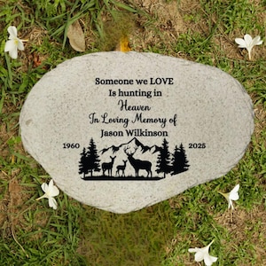May include: A gray stone memorial with the text "Someone we LOVE Is hunting in Heaven In Loving Memory of Jason Wilkinson 1960-2025". The memorial features a silhouette of deer and trees.