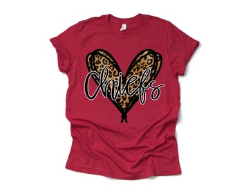 May include: Red t-shirt with a leopard print heart and the word "Chiefs" in black script.