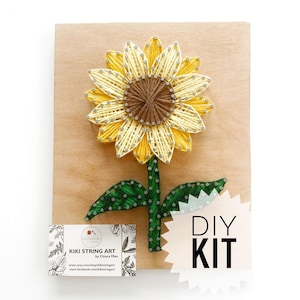 May include: DIY string art kit featuring a sunflower design. The kit includes all the materials needed to create the artwork, including a wooden base, string, and nails. The finished artwork is approximately 8 inches in diameter.