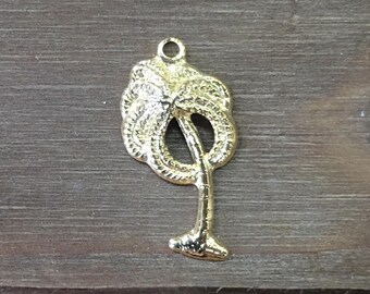 May include: A gold-colored metal palm tree charm. The charm is about 1 inch tall and has a detailed design.
