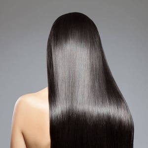 May include: A person with long, straight, black hair. The hair is very shiny and smooth.