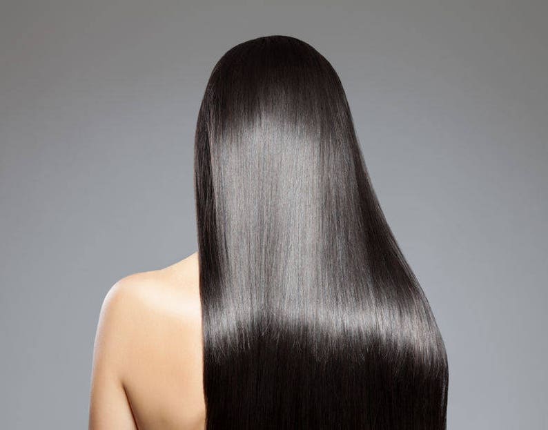 May include: A person with long, straight, black hair. The hair is very shiny and smooth.