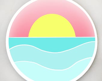 May include: A circular sticker featuring a graphic illustration of a sunset over the ocean. The design includes a bright yellow sun set against a pink sky, positioned above a turquoise sea with two white wavy lines representing gentle ocean waves.