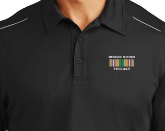 May include: A black polo shirt with a grey stripe on the shoulders. The shirt has an embroidered patch on the left chest that says "Desert Storm Veteran" and features a military ribbon.