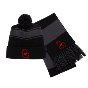 May include: Black and gray striped knit beanie with a black pom pom and a red embroidered Georgia state outline with a bulldog inside. A matching black and gray striped scarf with a black fringe.