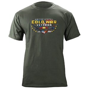 May include: A green t-shirt with a graphic design of crossed rifles, a US flag, and a Vietnam flag. The text "UNITED STATES COLD WAR VETERAN" is printed on the shirt.