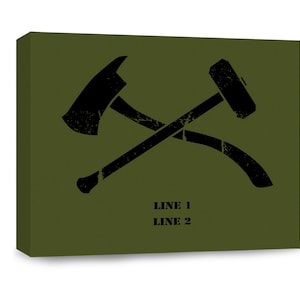 May include: A green canvas print with a black silhouette of a crossed axe and hammer. The text "LINE 1 LINE 2" is printed below the image.