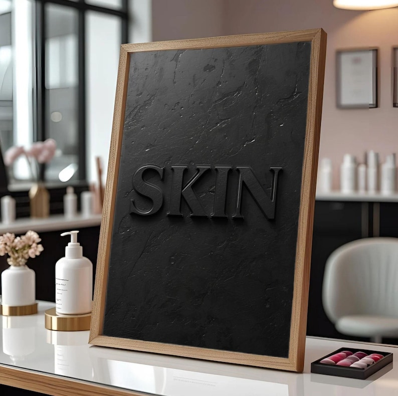 Minimalist printable wall art featuring the word "SKIN" embossed on a lightly textured, black concrete-style background, perfect for esthetician, dermatology office, med spa, or skincare gift decor.