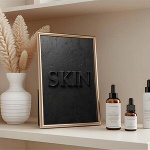 Minimalist printable wall art featuring the word "SKIN" embossed on a lightly textured, black concrete-style background, perfect for esthetician, dermatology office, med spa, or skincare gift decor.