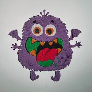 Puede incluir: Monstruo morado con dientes verdes y naranjas, una lengua roja y baba verde. El monstruo tiene ojos grandes, alas pequeñas y un cuerpo morado peludo.