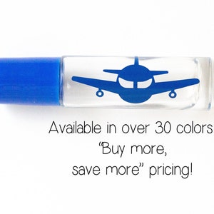 May include: A clear glass roller bottle with a blue cap and a blue airplane decal. The bottle is labeled "Available in over 30 colors! 'Buy more, save more' pricing!"