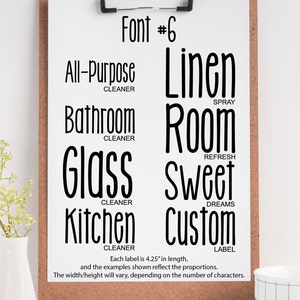 May include: A white board with a black clipboard attached to it. The clipboard has a sheet of paper with the text "Font #6" at the top. Below the text are eight labels with different text and descriptions, such as "All-Purpose Cleaner", "Linen Spray", "Bathroom Cleaner", "Room Refresh", "Glass Cleaner", "Sweet Dreams", "Kitchen Cleaner", and "Custom Label". Each label is 4.25 inches in length.