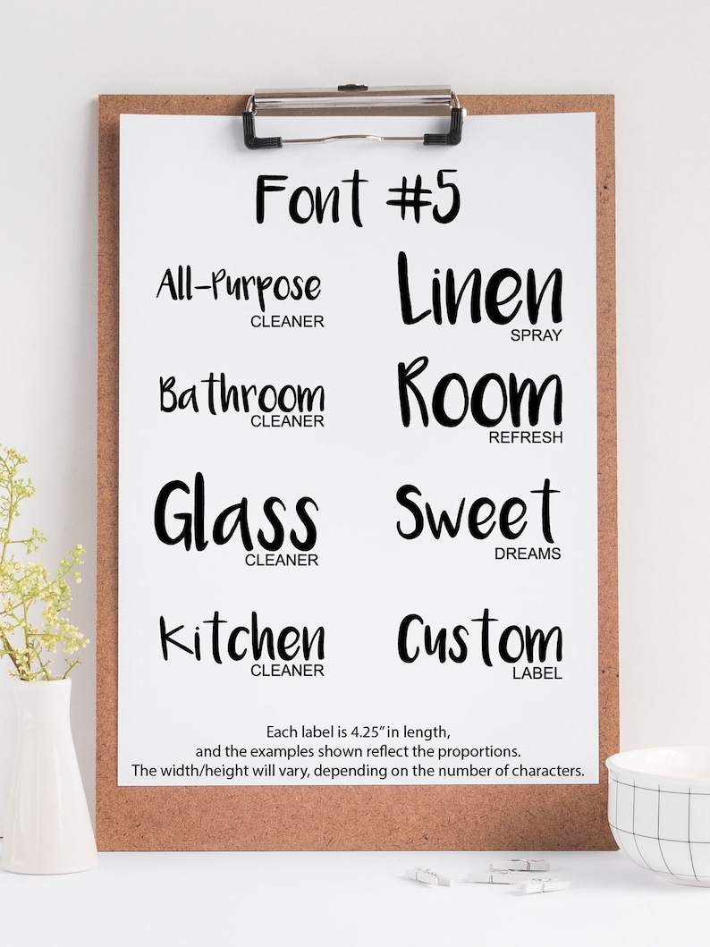 May include: A white sheet of paper with a black clipboard on top. The paper has the text "Font #5" at the top. Below the text are six different labels with the text "All-Purpose Cleaner", "Linen Spray", "Bathroom Cleaner", "Room Refresh", "Glass Cleaner", "Sweet Dreams", "Kitchen Cleaner", and "Custom Label". Each label is 4.25 inches long.
