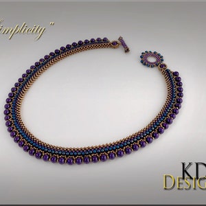May include: A purple and copper beaded necklace with a toggle clasp. The necklace is called "Simplicity".