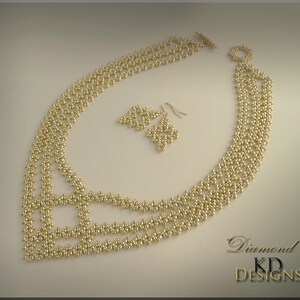 May include: A gold beaded necklace and matching earrings. The necklace is made of small, round beads arranged in a geometric pattern. The earrings are simple and dangle from the earlobes. The text "Diamond" and "KD Designs" is visible in the bottom right corner of the image.