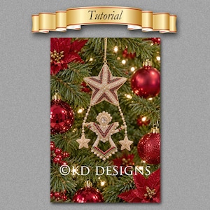 May include: A beaded Christmas ornament featuring a large star at the top connected by beaded strands to a central angel figure holding two smaller stars. The ornament is crafted with red, white, and gold beads. The text KD DESIGNS is visible.