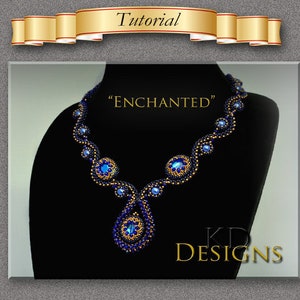 May include: A beaded necklace with a teardrop pendant, featuring blue and gold beads. The necklace is displayed on a black mannequin and the text "ENCHANTED" and "KD DESIGNS" is visible.