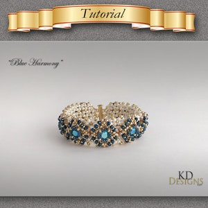 May include: A beaded bracelet with a blue and gold design. The bracelet is called "Blue Harmony" and is made by KD Designs.