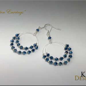 May include: A pair of silver hoop earrings with a double row of dark blue crystal beads. The earrings are labeled "Illusion Earrings".