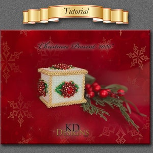 May include: A white beaded box with red and green bead embellishments. The box is decorated with a Christmas theme and the text "Christmas Present 2020". The box is sitting on a red background with white snowflakes.