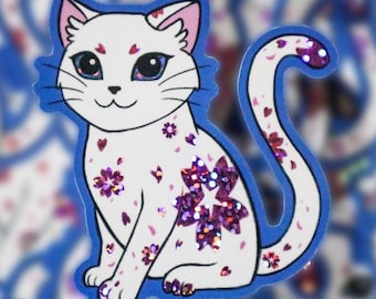 May include: A white cat sticker with pink and purple glitter accents. The cat is sitting with its tail curled around its body. The sticker is on a blue background.