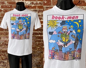 90s Book Man Kiki Suarez Art T-Shirt. Vintage 1990 Kiki Suarez Book Man Art Tee Single Stitch Made in USA - Medium 19" x 26"