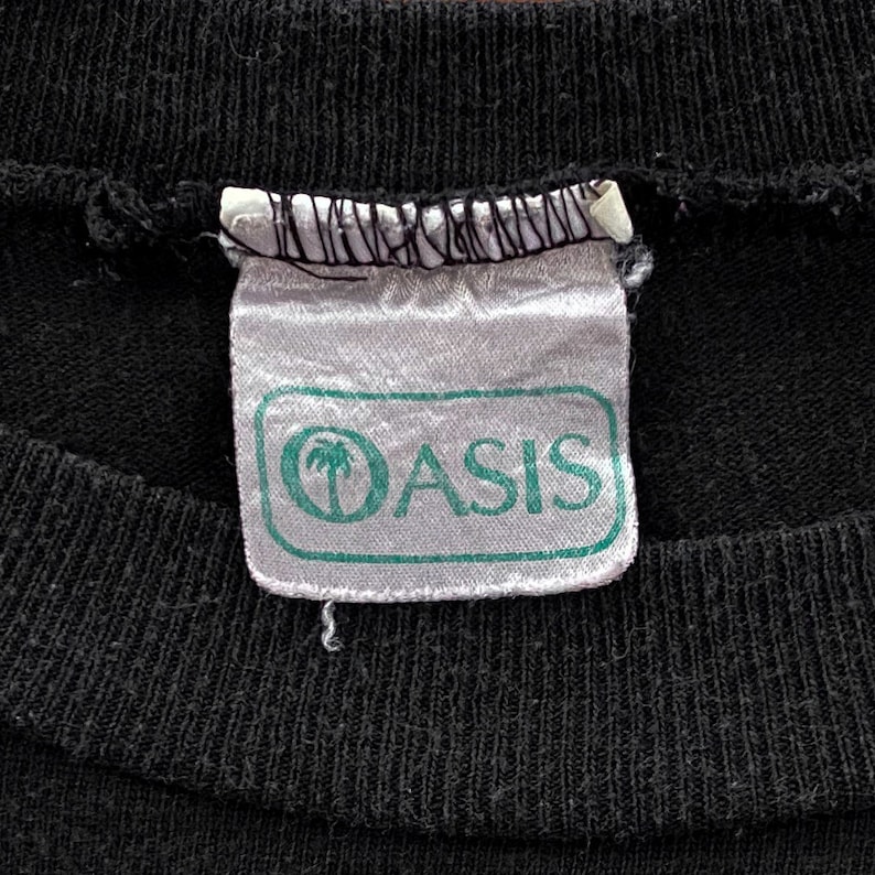 May include: A white tag with a green border and the word "Oasis" in black text. A palm tree icon is to the left of the word "Oasis".