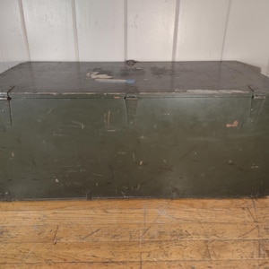 May include: A vintage green wooden storage chest with metal hardware and a worn surface.