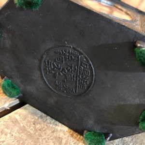 May include: Black hexagonal box with a circular seal on the bottom. The seal has Chinese characters in gold. The box has five green felt feet.